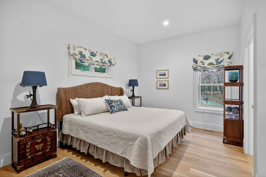 280 Ice Valley Road Osterville, MA 02655 - Photo 26 of 42 a bedroom with a bed and wooden floor