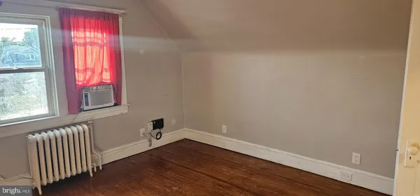 a view of a room with wooden floor and windows