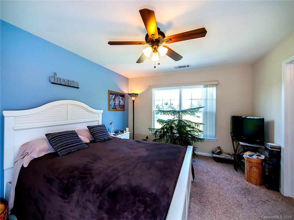 264 River Clay Road, Unit 211 Fort Mill, SC 29708 - Photo 13 of 23 a bedroom with a bed and a flat screen tv