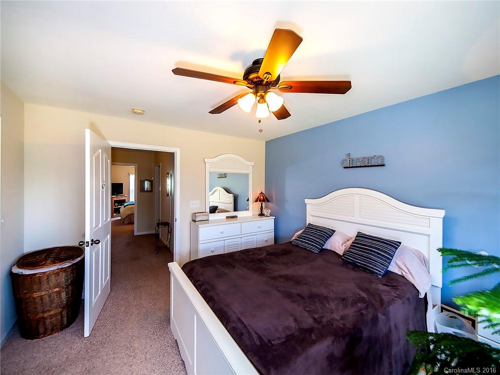 264 River Clay Road, Unit 211 Fort Mill, SC 29708 - Photo 14 of 23 a bedroom with a bed and a chandelier