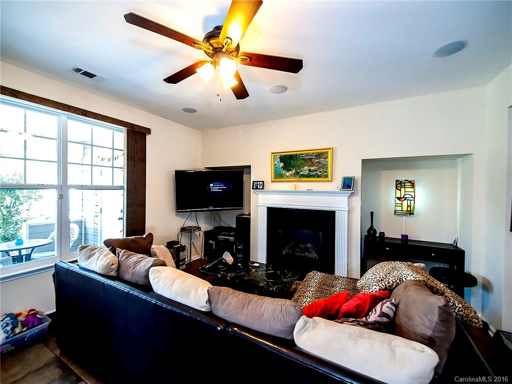 264 River Clay Road, Unit 211 Fort Mill, SC 29708 - Photo 5 of 23 a living room with furniture a flat screen tv and a fireplace