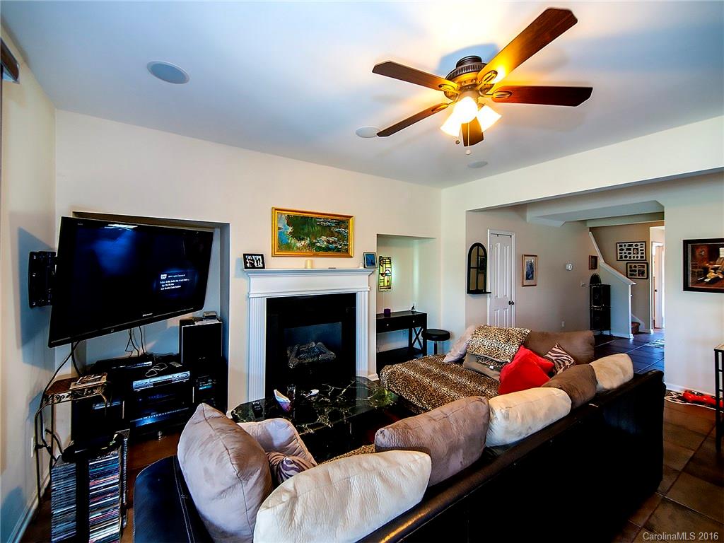 264 River Clay Road, Unit 211 Fort Mill, SC 29708 - Photo 6 of 23 a living room with furniture a flat screen tv and a fireplace