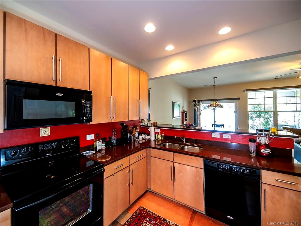 264 River Clay Road, Unit 211 Fort Mill, SC 29708 - Photo 8 of 23 a kitchen with stainless steel appliances sink stove and cabinets
