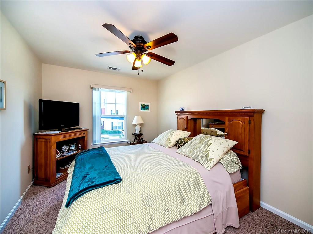 264 River Clay Road, Unit 211 Fort Mill, SC 29708 - Photo 10 of 23 a bedroom with a bed and a flat screen tv