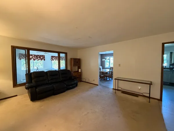 a living room with furniture and a mirror