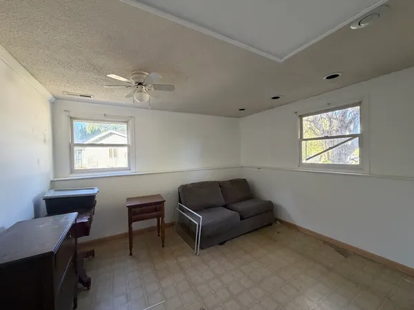 a living room with furniture a window and a work place