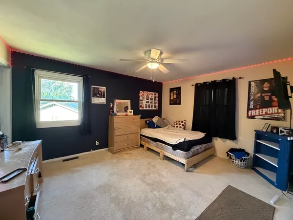 a bedroom with furniture and window