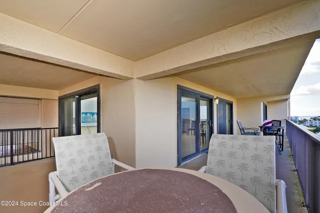 a bedroom with two beds and a chandelier