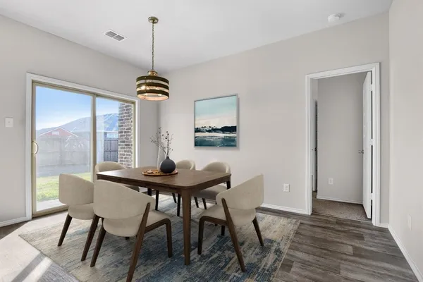 a view of a dining room with furniture window and wooden floor