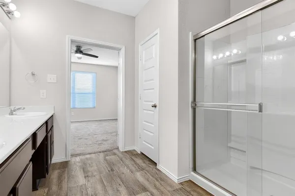 a bathroom with a mirror and a shower