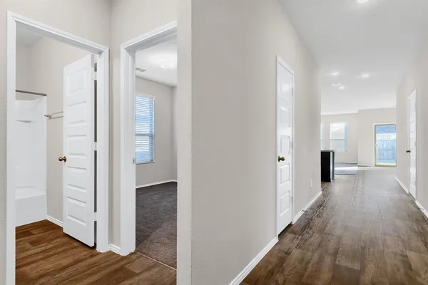 a view of a hallway with wooden floor