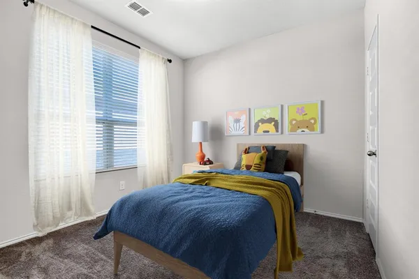 a bedroom with a bed and a window