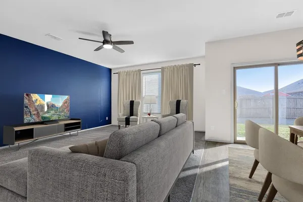 a living room with furniture and a flat screen tv