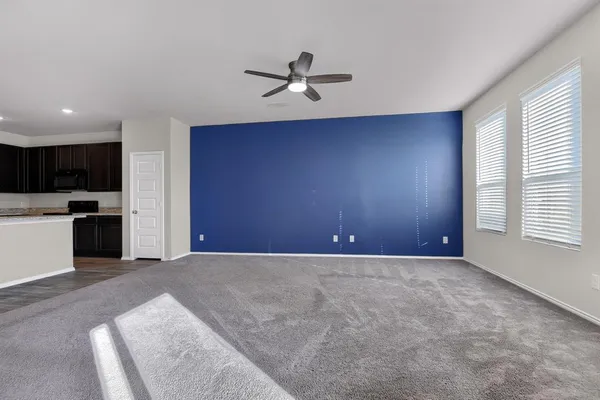 a view of a livingroom with a ceiling fan and window