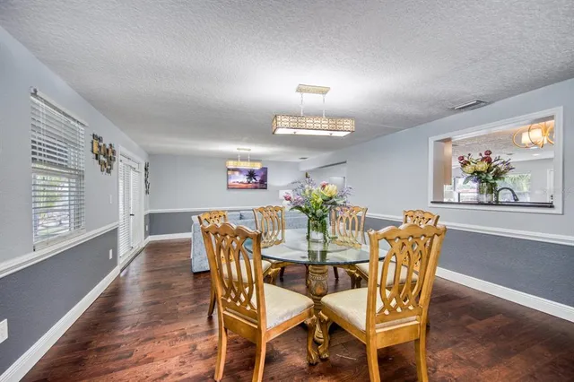a view of a dining room with furniture and wooden floor