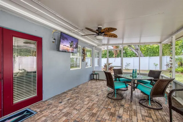 a backyard of a house with table and chairs