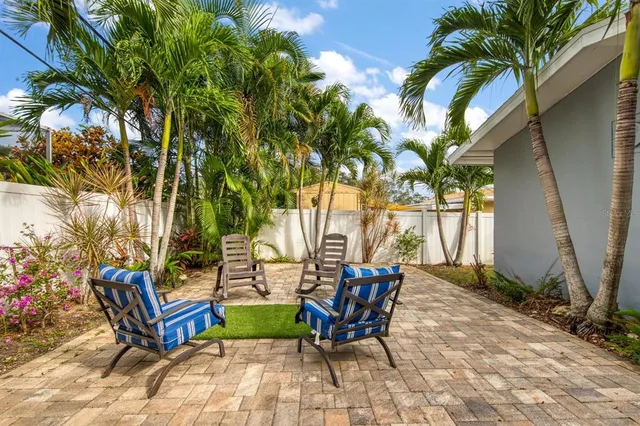 a view of backyard with sitting area and slide