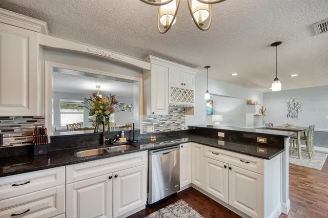 a kitchen with a sink and cabinets
