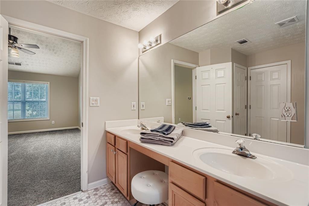 2409 Caneridge Way Southwest Marietta, GA 30064 - Photo 20 of 28 a bathroom with a granite countertop sink and a mirror