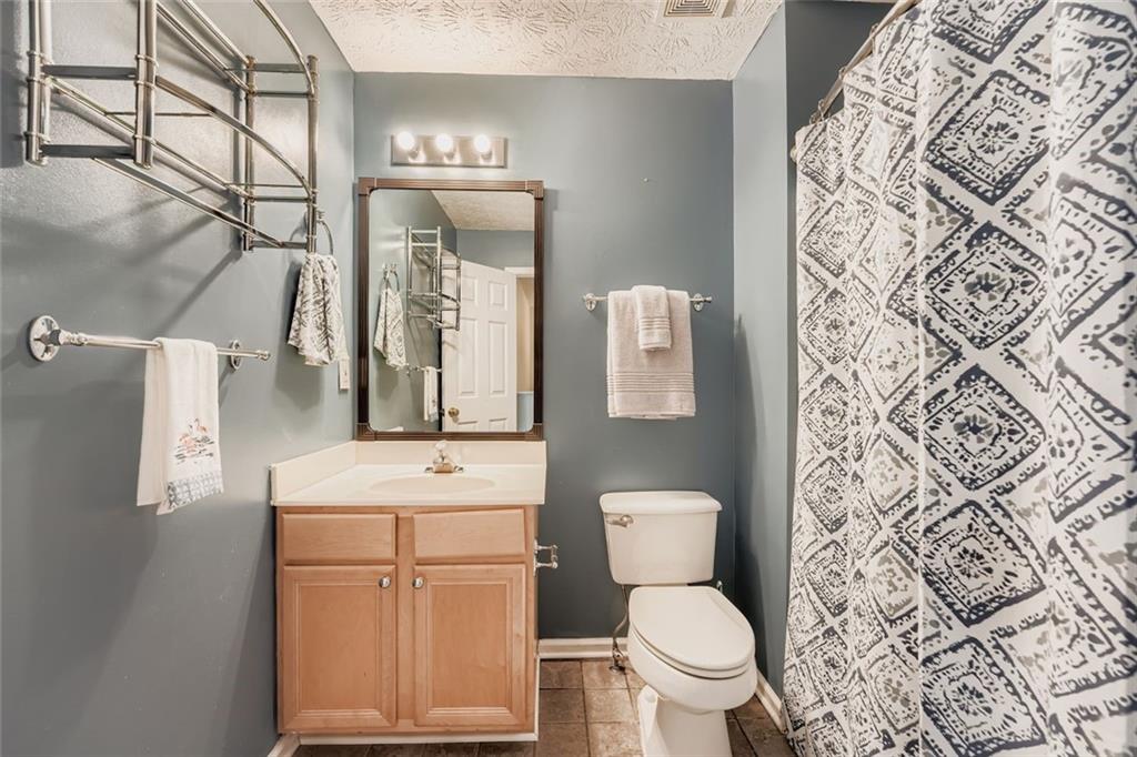 2409 Caneridge Way Southwest Marietta, GA 30064 - Photo 22 of 28 a bathroom with a toilet sink and mirror