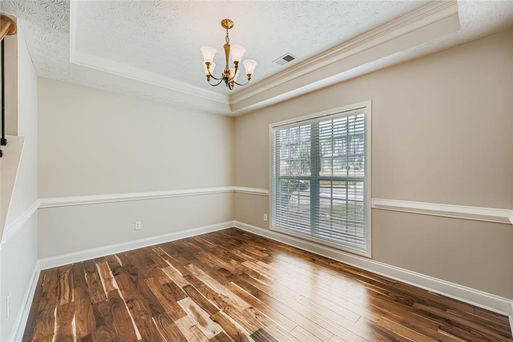 2409 Caneridge Way Southwest Marietta, GA 30064 - Photo 7 of 28 a view of an empty room with wooden floor and a window