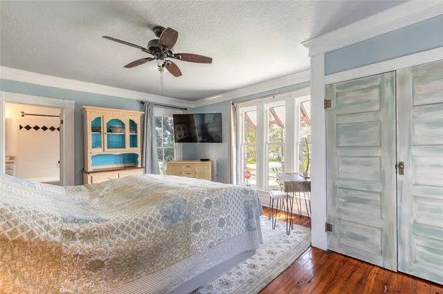 a bedroom with a bed a chair and a window