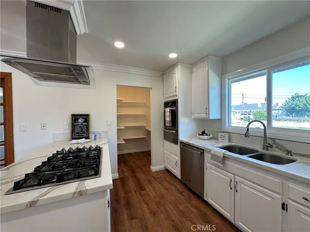 a kitchen with stainless steel appliances a sink and a stove
