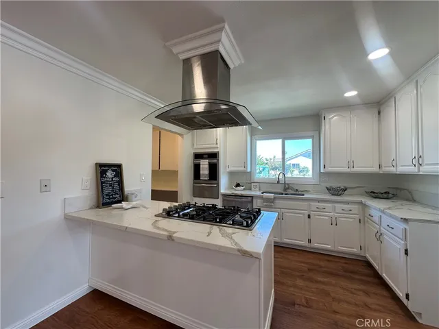 a kitchen with a stove and a sink