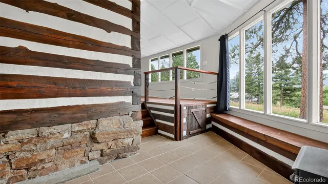 a view of a room with wooden floor and windows