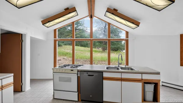 a kitchen with stainless steel appliances granite countertop a sink and a window