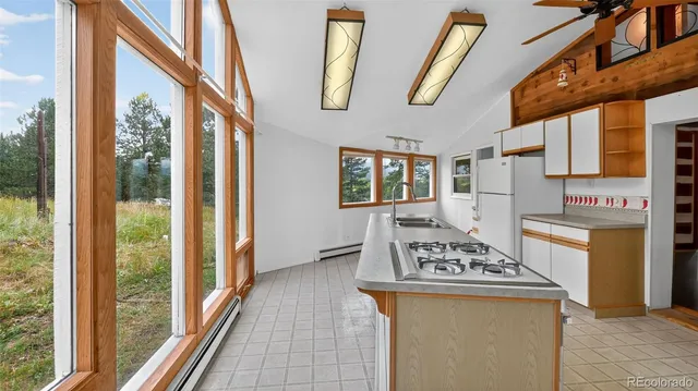 a kitchen with stainless steel appliances granite countertop a stove and a refrigerator