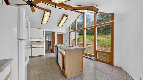 a kitchen with stainless steel appliances granite countertop a stove and a refrigerator