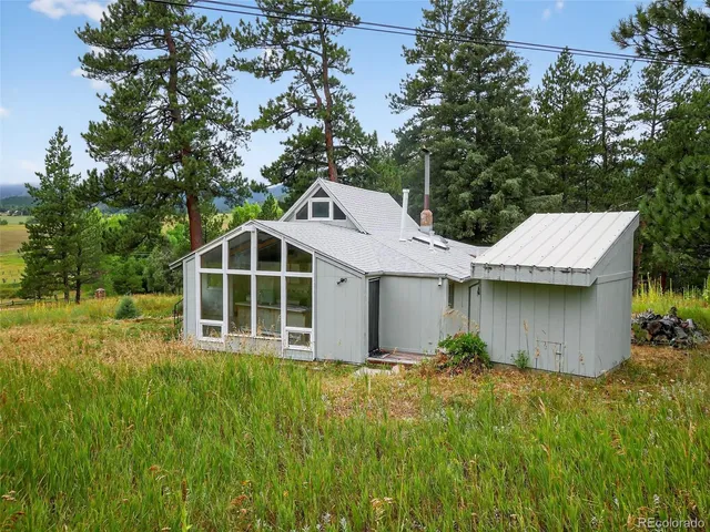 a view of a house with a yard and potted plants