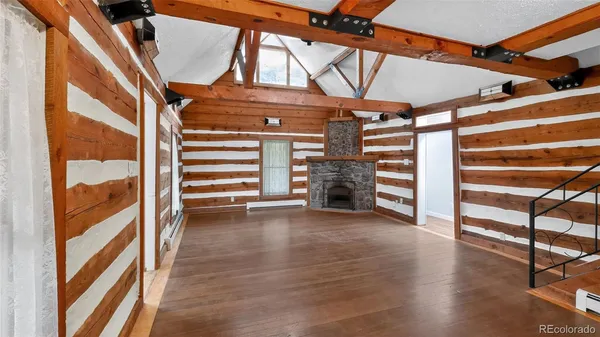 a view of an empty room with a fireplace and a window
