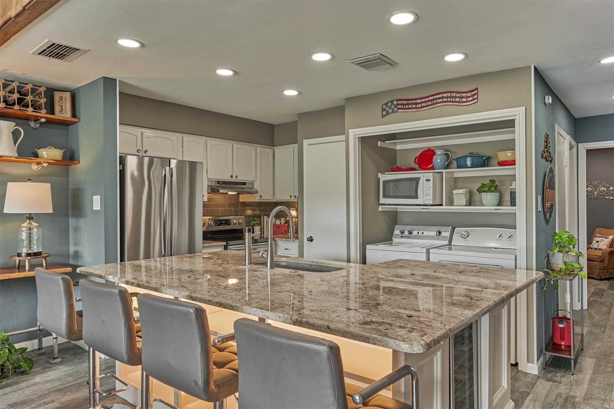 1 April Point Drive South Montgomery, TX 77356 - Photo 5 of 45 a kitchen with stainless steel appliances granite countertop a sink refrigerator and cabinets