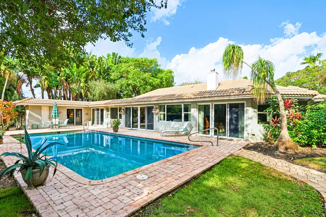 a view of a house with a yard and sitting area