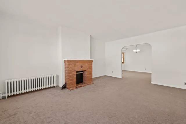 an empty room with fireplace