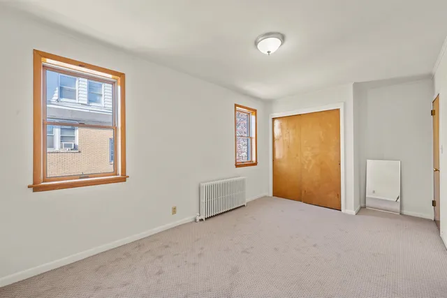 an empty room with windows and closet