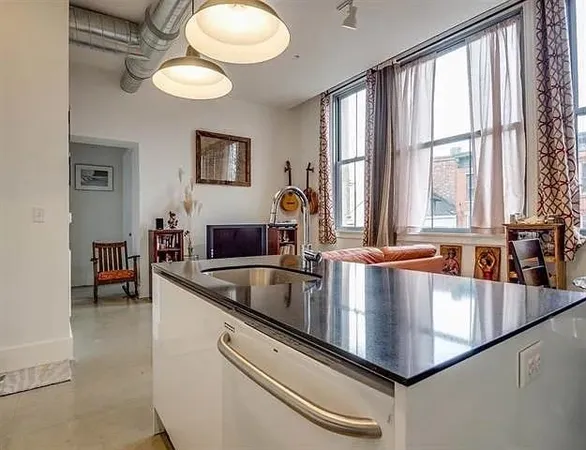 a kitchen with a large window and cabinets