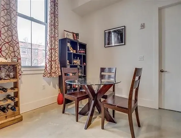 a view of a dining room with furniture and a window