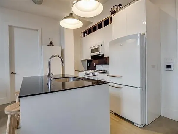 a kitchen with stainless steel appliances a sink and a refrigerator