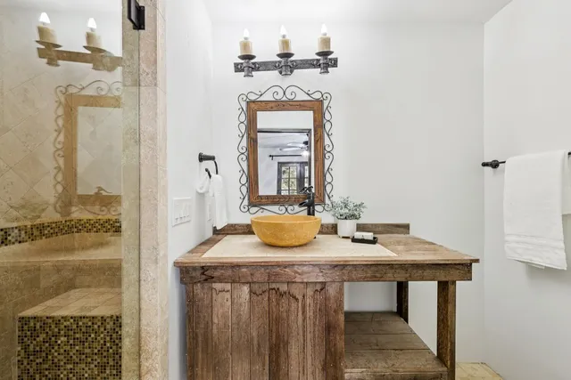 a view of a bathroom with a sink and a mirror