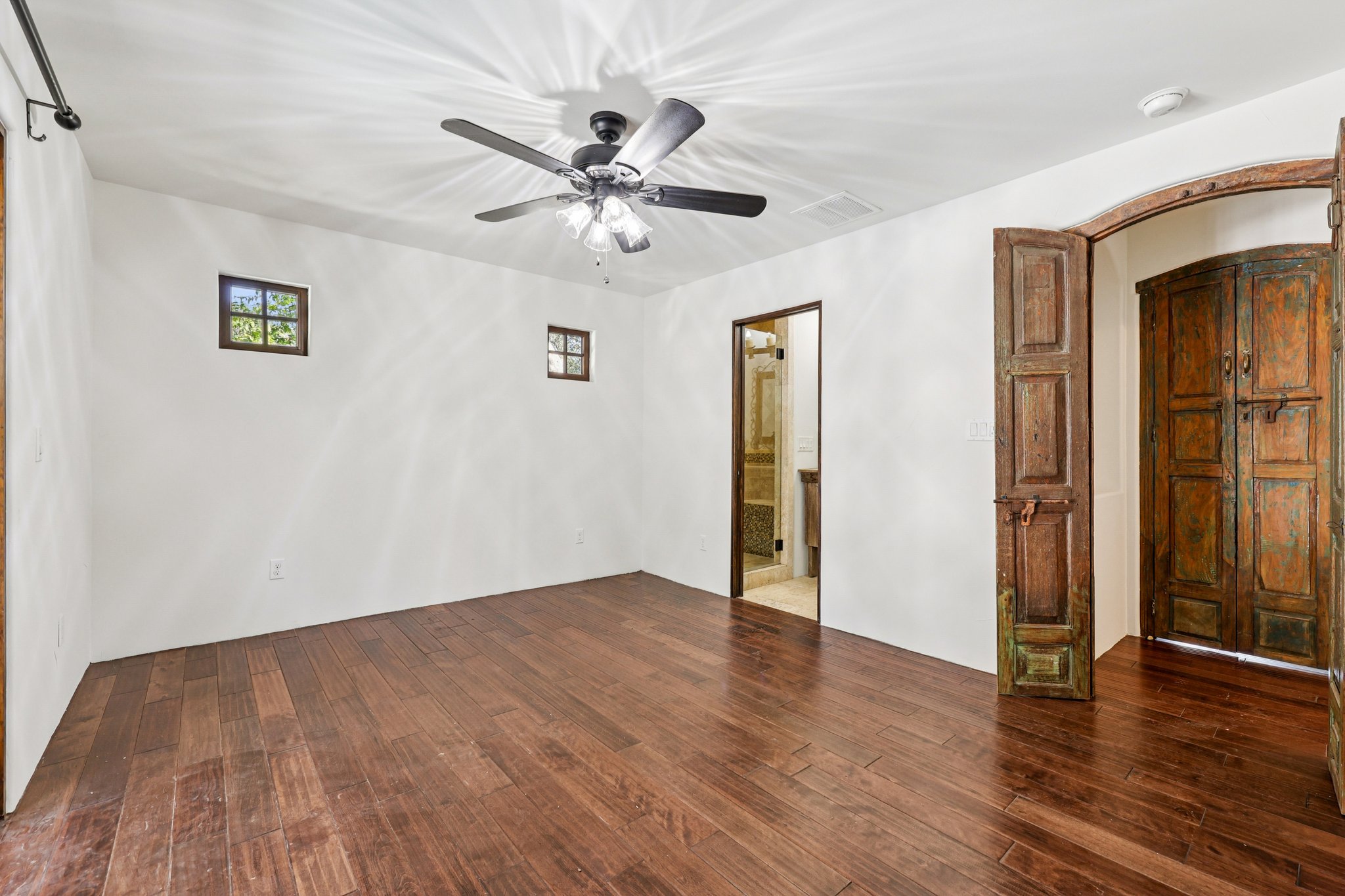 2706 Pearce Road Austin, TX 78730 - Photo 18 of 37 an empty room with wooden floor closet and windows