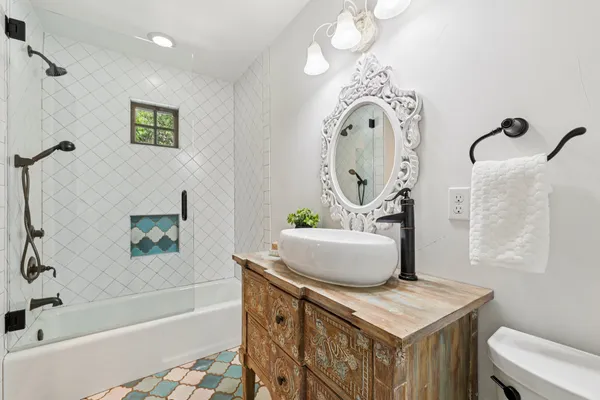 a bathroom with a sink a mirror and a bathtub