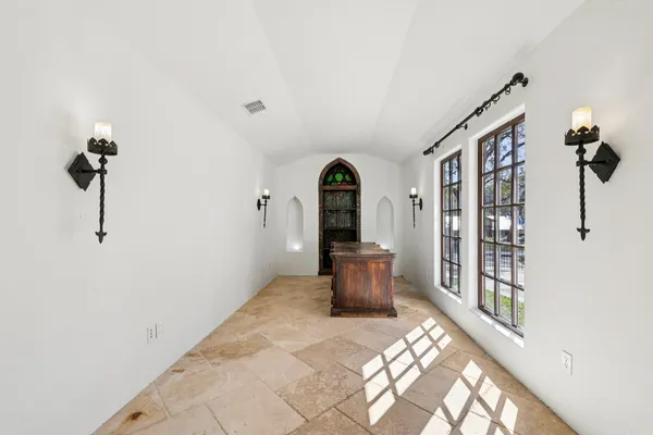 a view of a balcony with two chairs and a fire pit