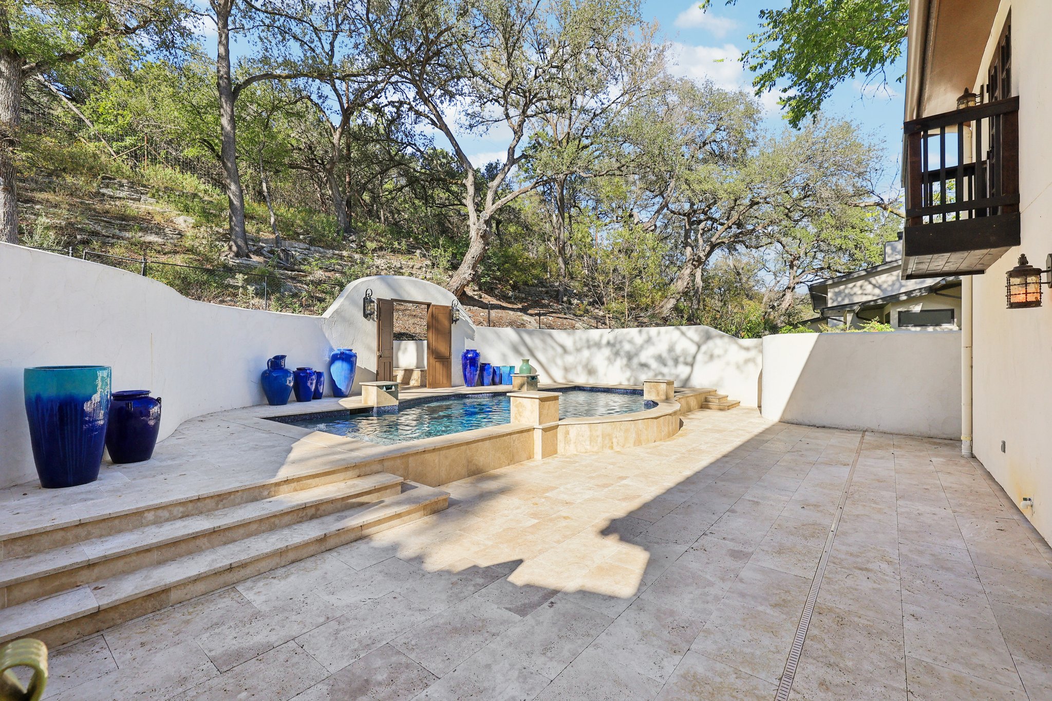 2706 Pearce Road Austin, TX 78730 - Photo 30 of 37 a view of a balcony with two chairs and a fire pit
