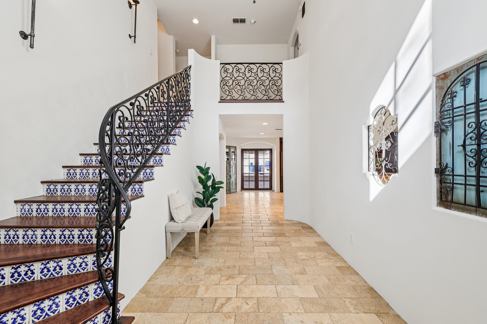 2706 Pearce Road Austin, TX 78730 - Photo 5 of 37 a hallway with a large entryway and paintings on the wall
