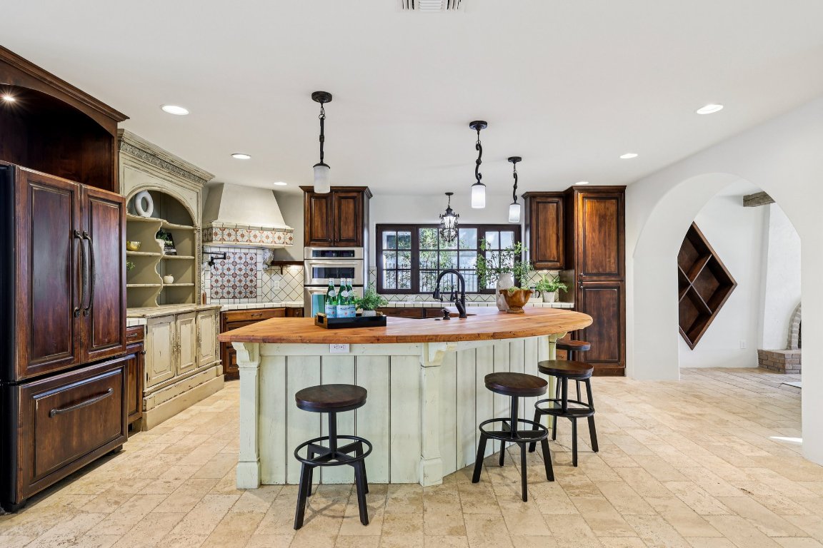 2706 Pearce Road Austin, TX 78730 - Photo 6 of 38 A rustic showpiece kitchen designed specifically for the culinary enthusiast with massive curved butcher-block island serves as the heart of the home.