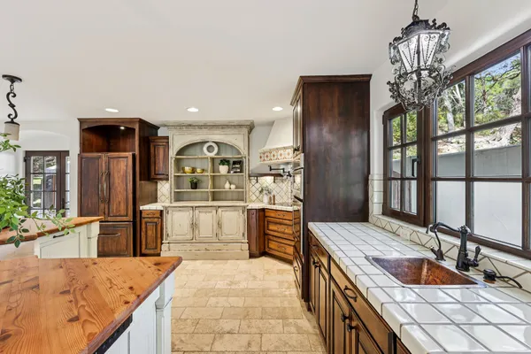 a kitchen with granite countertop a sink stove and refrigerator