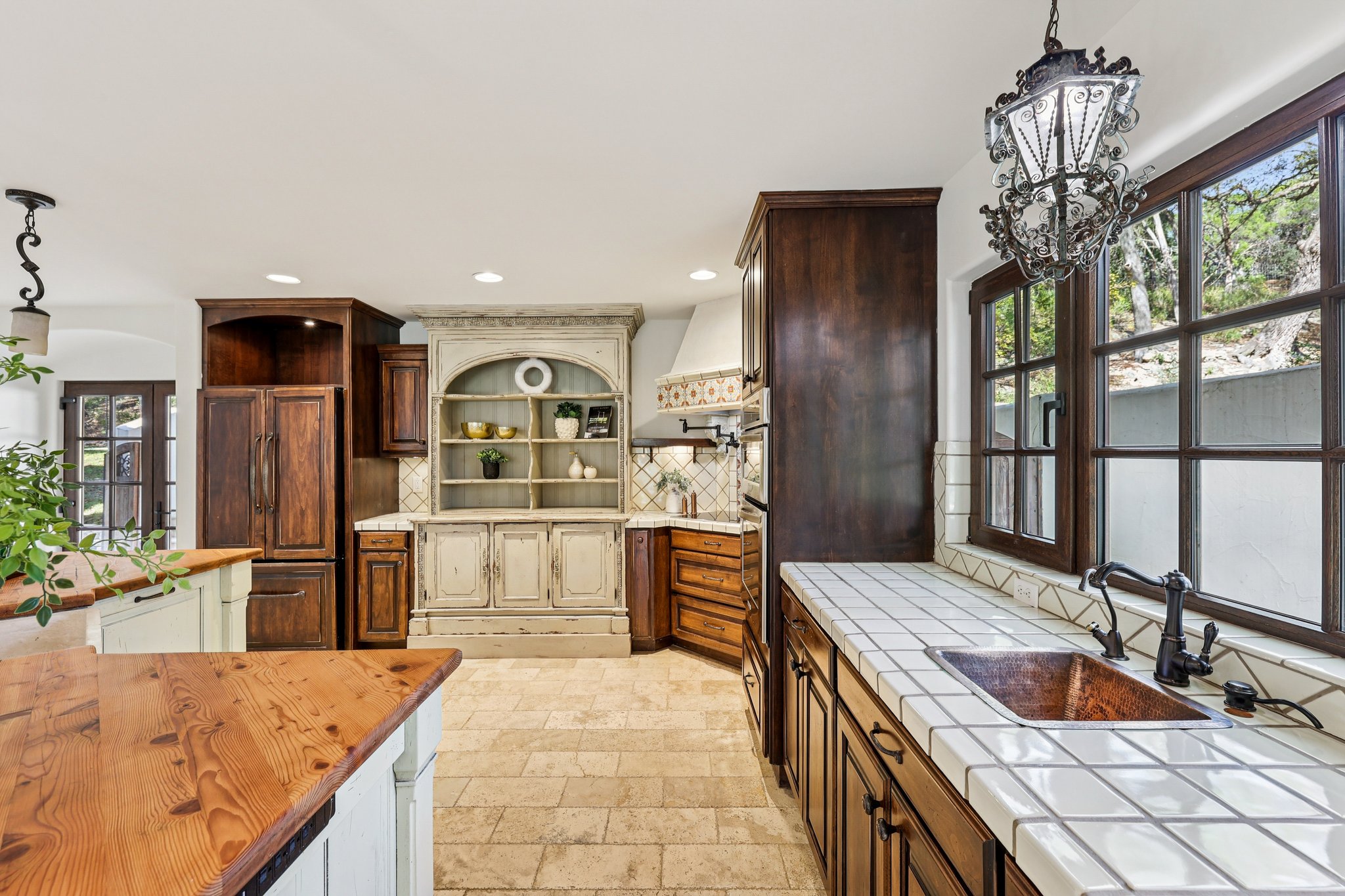 2706 Pearce Road Austin, TX 78730 - Photo 6 of 37 a kitchen with granite countertop a sink stove and refrigerator